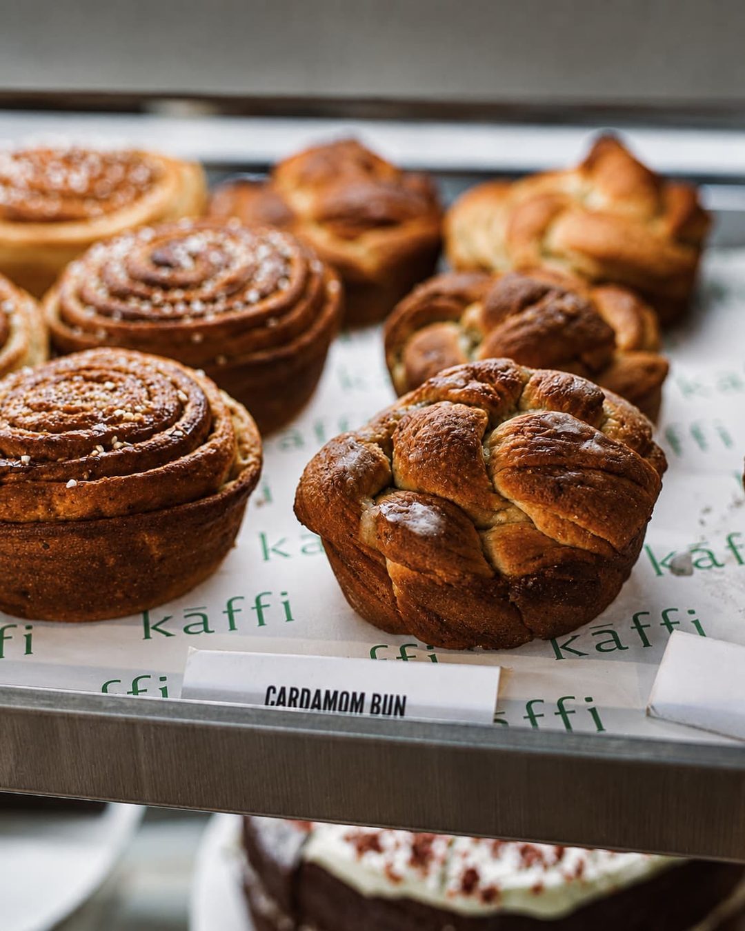 A tray of cardamom buns on printed Kāffi label paper