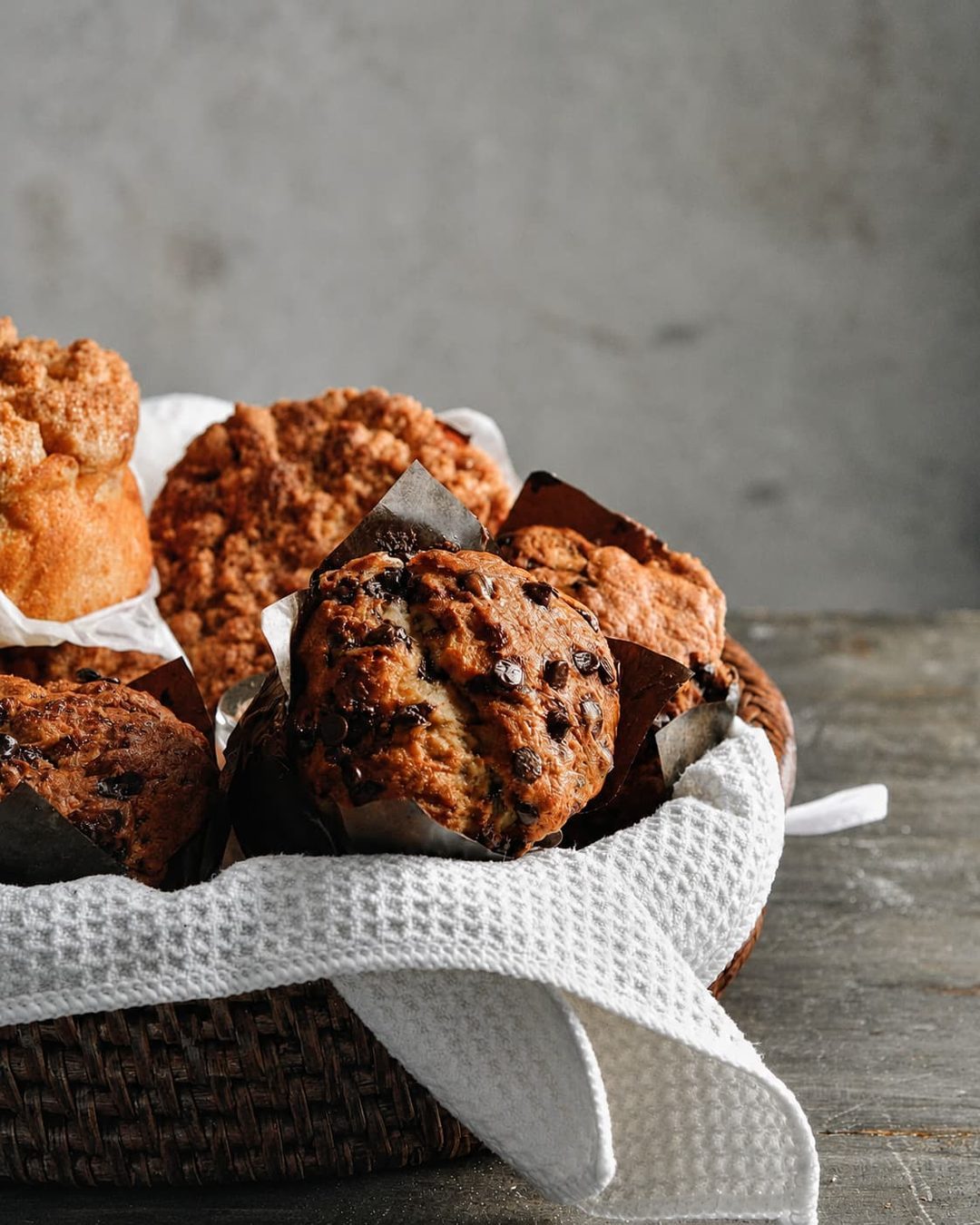 A basket of muffins wrapped in a waffle cloth